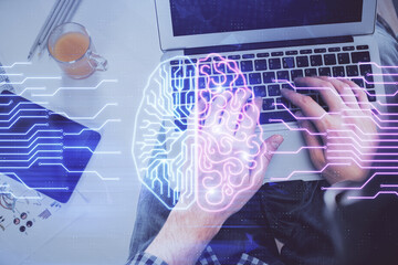 Double exposure of man's hands typing over computer keyboard and brain hologram drawing. Top view. Ai and data technology concept.