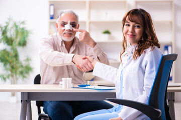Old man visiting young female doctor for plastic surgery