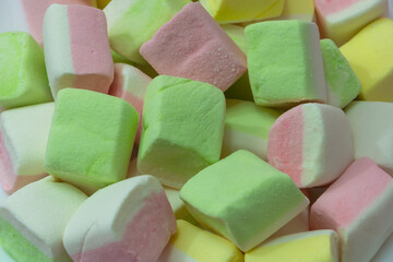 Marshmallow close-up. Pink, green and yellow dessert color. Light dessert, sweets