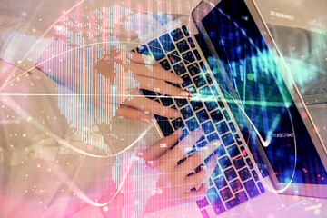 Double exposure of woman hands working on computer and financial theme hologram drawing. Top View. Business concept.