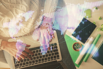 Double exposure of woman hands working on computer and financial theme hologram drawing. Top View....