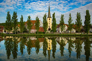 A church on the bank of the Main River with a perfect reflection, at Baden-Wurttemberg, Germany