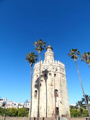 Fototapeta premium A view of the Guadalquivir River and the Golden Tower, Torre del Oro, in Seville, Sevilla, Andalusia, Spain.