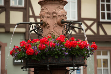 flowers and sculpture in the city square, Miltenberg, Bavaria, Germany
