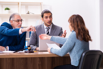 Young woman in courthouse with judge and lawyer