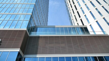 Obraz na płótnie Canvas Bottom view of glass silhouette of skyscraper. Business building. Skyscraper with glass facade. Modern building in business district. Concepts of economics, financial, future. 