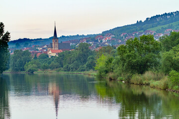 Obraz premium A church in a residential area on the bank of the Main River in Baden-Wurttemberg, Germany