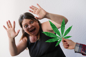scary woman with bulging eyes happily opened her mouth, shouts, closing her hands by hand offering...
