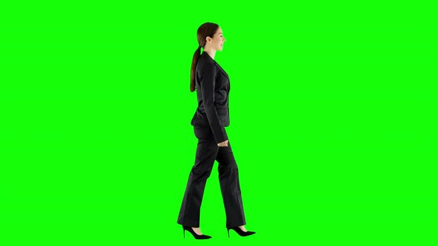 Young Businesswoman Walking Across an Office Wearing Black Suit Green Screen