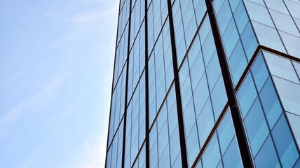 Fototapeta na wymiar Bottom view of glass silhouette of skyscraper. Business building. Skyscraper with glass facade. Modern building in business district. Concepts of economics, financial, future. 