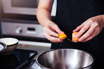 Woman girl baker in kitchen cooking whisk egg to bowl for bakery cake