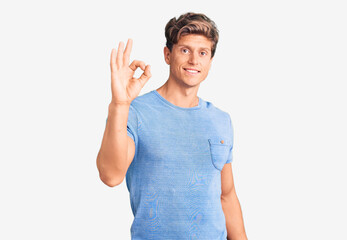 Obraz na płótnie Canvas Young handsome man wearing casual clothes smiling positive doing ok sign with hand and fingers. successful expression.