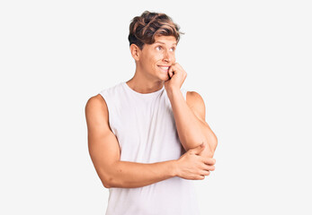 Fototapeta premium Young handsome man wearing sleveeless t shirt looking stressed and nervous with hands on mouth biting nails. anxiety problem.