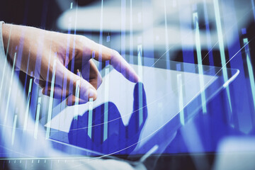 Multi exposure of man's hands holding and using a phone and financial chart drawing. Market analysis concept.