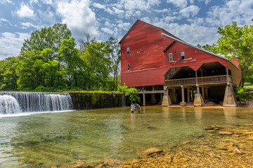 An old red mill and a dam.