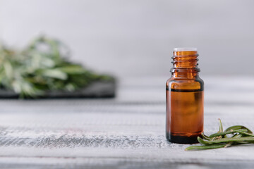 Bottle of rosemary essential oil on table