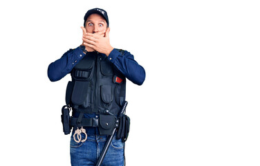 Young handsome man wearing police uniform shocked covering mouth with hands for mistake. secret concept.