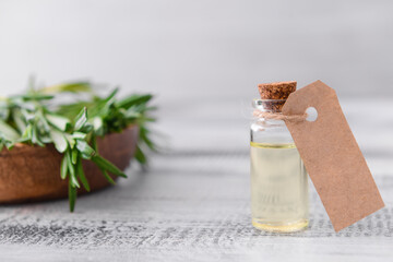 Bottle of rosemary essential oil on table
