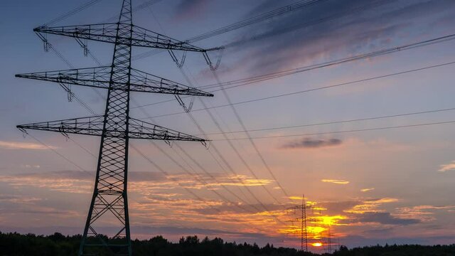 Power Line Timelapse with beautiful Sundown Pan Up