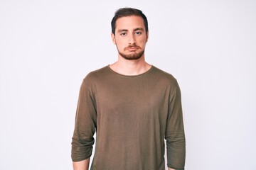 Fototapeta premium Young handsome man wearing casual clothes depressed and worry for distress, crying angry and afraid. sad expression.