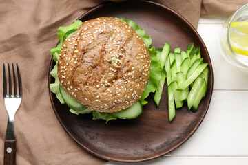 Plate with tasty vegan burger on table
