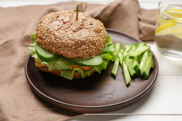 Plate with tasty vegan burger on table