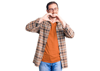 Young handsome caucasian man wearing casual clothes and glasses smiling in love showing heart symbol and shape with hands. romantic concept.