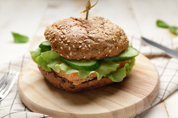 Board with tasty vegan burger on table