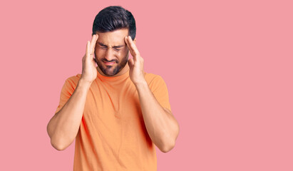 Young hispanic man wearing casual clothes suffering from headache desperate and stressed because pain and migraine. hands on head.