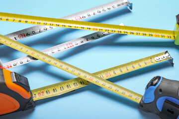 Measuring tapes on color background