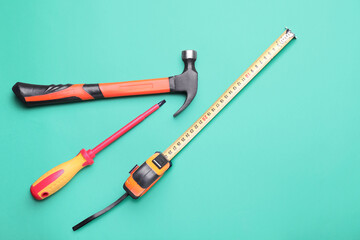 Fototapeta premium Measuring tape with builder's supplies on color background