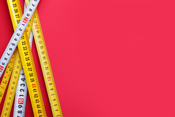 Measuring tapes on color background