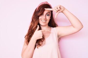 Young beautiful woman wearing casual clothes smiling making frame with hands and fingers with happy face. creativity and photography concept.