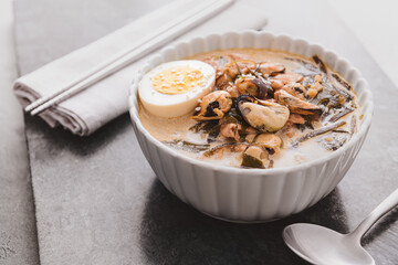 Bowl with tasty seaweed soup on table