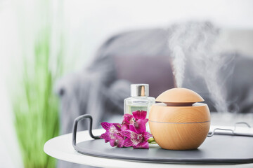 Aroma oil diffuser on table in room