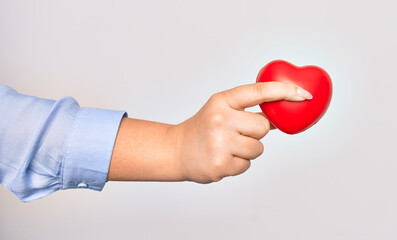 Hand of caucasian young woman holding red heart over isolated white background