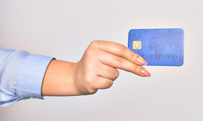 Hand of caucasian young woman holding credit card over isolated white background