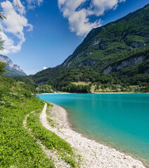 Panorama of Lake Tenno surrounded by Italian mountains with turqoise water