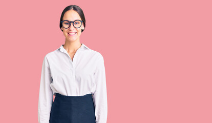 Beautiful brunette young woman wearing professional waitress apron with a happy and cool smile on face. lucky person.