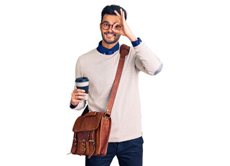 Young handsome hispanic man wearing leather bag and drinking take away coffee smiling happy doing ok sign with hand on eye looking through fingers