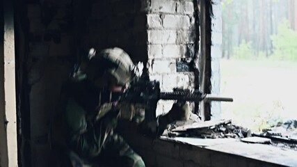 Military soldier in the form holds in the hands an assault rifle, check possible enemies around the corner - Powered by Adobe