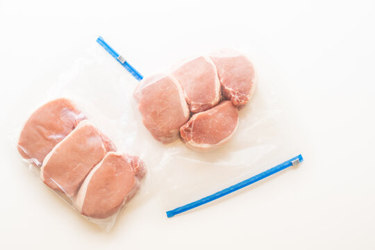 Zip Lock Bags With Boneless Pork Loin Chops, Close Up, White Background, Directly From Above