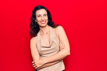 Young beautiful hispanic woman wearing casual clothes happy face smiling with crossed arms looking at the camera. positive person.