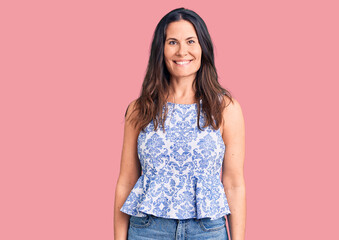 Young beautiful brunette woman wearing casual t-shirt with a happy and cool smile on face. lucky person.