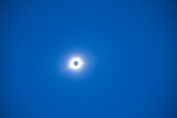 Naklejka na ściany i meble Total eclipse of the sun with blue sky