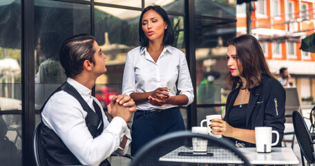Group of cheerful young friend discussing meeting and talk enjoying their time drinking coffee together.Mixed race people sitting at cafe table and restaurant
