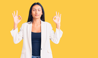 Young beautiful latin girl wearing business clothes relax and smiling with eyes closed doing meditation gesture with fingers. yoga concept.