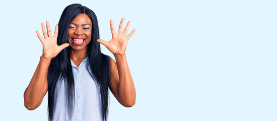 Fototapeta na wymiar Young african american woman wearing casual clothes showing and pointing up with fingers number ten while smiling confident and happy.