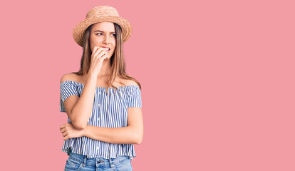 Young beautiful girl wearing hat and t shirt looking stressed and nervous with hands on mouth biting nails. anxiety problem.