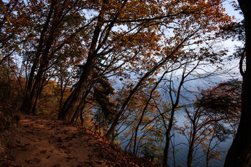 Beautiful autumn scenery,foggy mist over the lake and mountain.